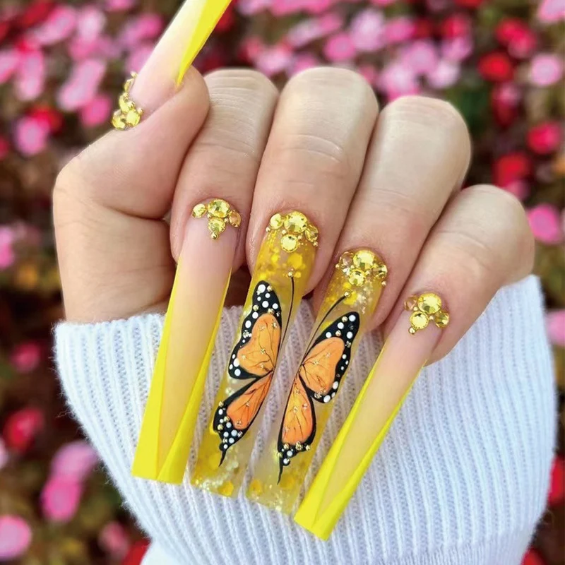 Kunstvolle Gel-Nägel mit Schmetterlings-Design und Glitzer Karnz