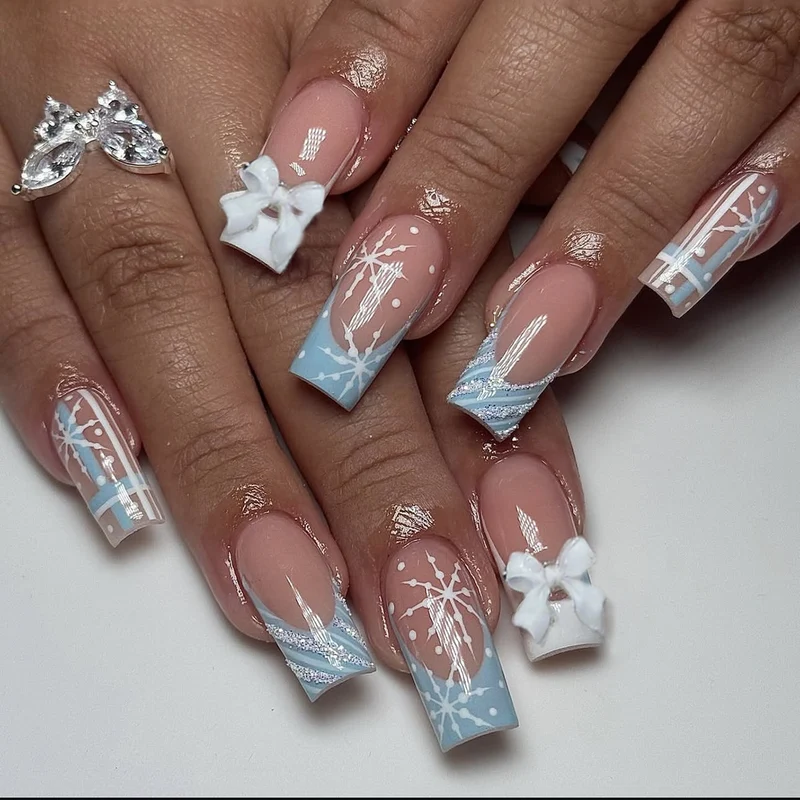 Kunstnagelset mit winterlichen Schneeflocken- und Schleifenmotiven Karnz