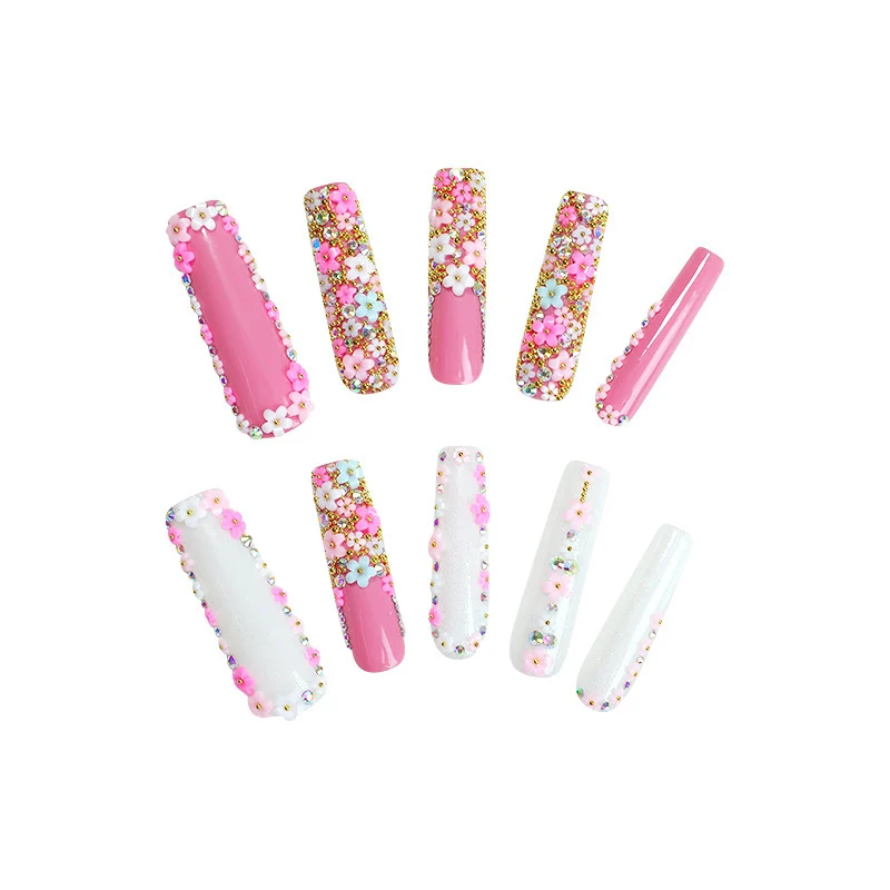 Kunstnagelset mit floralen Verzierungen und Glitzerakzenten Karnz